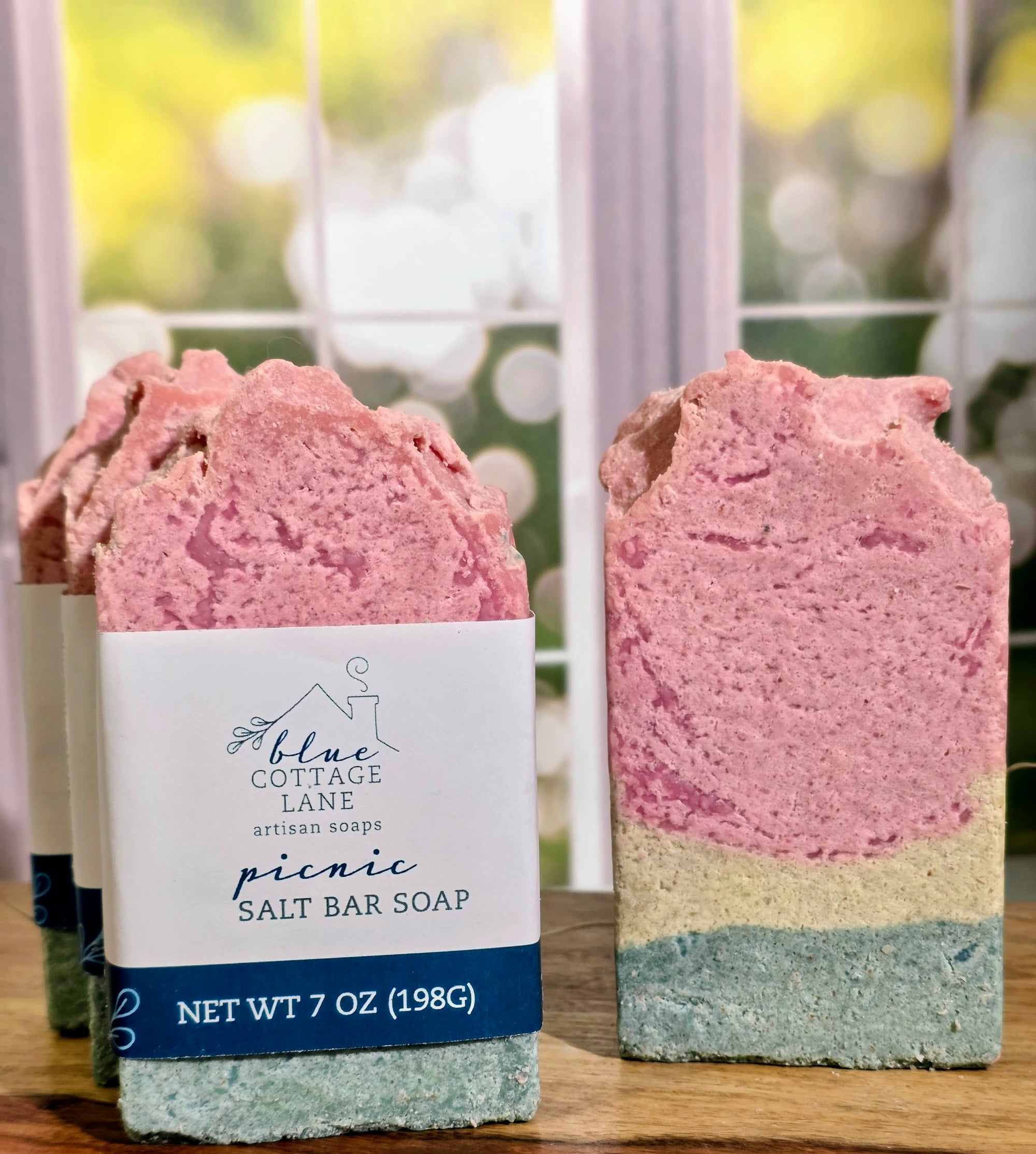 Four Salt bars with layers of green, light green and pink.  Three bars on left with label.